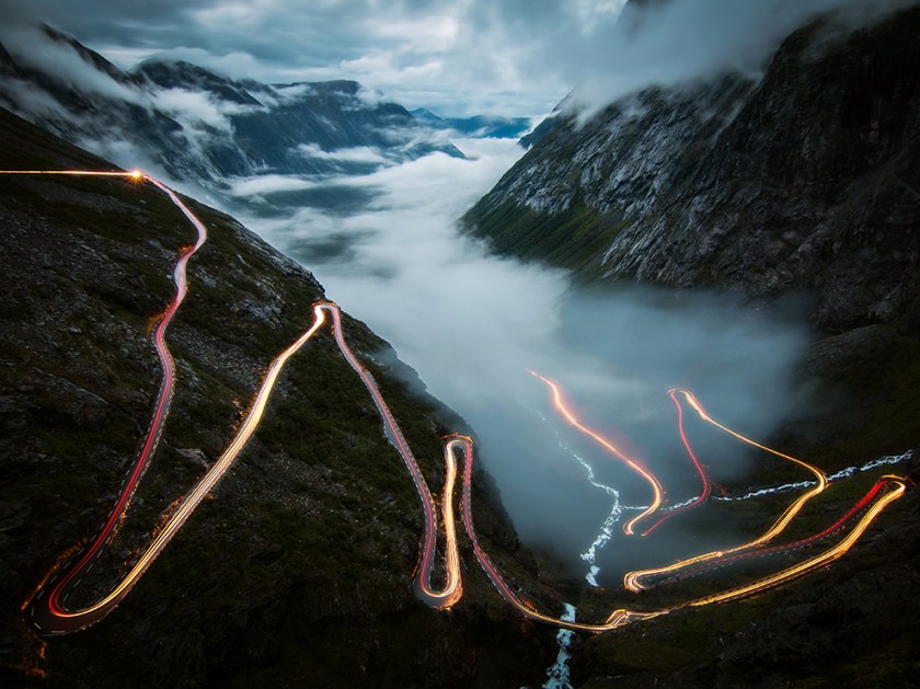 I took this photo in july 2014 at Trollstigen in Norway. Standing there alone in the fog, I was waiting for the view to become clear. And then it happened, the fog disappeared and though it was 1 am already, one car came slowly up the steep serpentines. It was my dream for a long time to take a photo of lighttrails like this in Norway - and it was just an awesome feeling that it worked out on the most beautiful and famous street. A few minutes later the fog returned, even thicker than before.